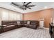Spacious living room with stylish tile flooring, recessed lights, and a comfortable leather sectional sofa at 2132 W Chambers St, Phoenix, AZ 85041