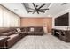 Spacious living room with stylish tile flooring, recessed lights, and a comfortable leather sectional sofa at 2132 W Chambers St, Phoenix, AZ 85041