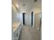 Bright bathroom with double sinks, white cabinets, and a glass-enclosed shower at 25138 W Wayland Dr, Buckeye, AZ 85326
