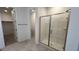 Bright bathroom featuring glass shower and neutral tile at 25138 W Wayland Dr, Buckeye, AZ 85326
