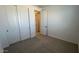Bedroom featuring carpeted floors and a closet with sliding doors at 25138 W Wayland Dr, Buckeye, AZ 85326