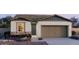 Charming single-story home featuring stone accents, neutral stucco, and a convenient two-car garage at 25138 W Wayland Dr, Buckeye, AZ 85326