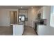 Bright kitchen featuring stainless appliances, granite counters, and island with sink at 25138 W Wayland Dr, Buckeye, AZ 85326