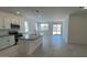 Bright kitchen featuring stainless appliances, granite counters, and island with sink at 25138 W Wayland Dr, Buckeye, AZ 85326