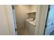 A laundry room features modern washer and dryer units plus a shelf at 25138 W Wayland Dr, Buckeye, AZ 85326