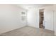 Bedroom features neutral carpeting, a large window, and white walls for a bright, clean look at 25455 N 183Rd Dr, Wittmann, AZ 85361