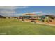 Expansive green community park featuring playground equipment, perfect for picnics and leisurely outdoor activities at 25455 N 183Rd Dr, Wittmann, AZ 85361