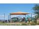 A community playground with slides and climbing structures offers a safe and engaging space for children to play and socialize at 25455 N 183Rd Dr, Wittmann, AZ 85361