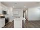 Kitchen featuring an island, white cabinets, stainless steel appliances, and wood flooring at 25455 N 183Rd Dr, Wittmann, AZ 85361