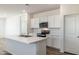 Kitchen featuring an island, white cabinets, stainless steel appliances, and wood flooring at 25455 N 183Rd Dr, Wittmann, AZ 85361