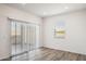 Bright living room features sleek wood-look flooring, slider door, and a window for ample natural light at 25455 N 183Rd Dr, Wittmann, AZ 85361
