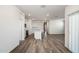 Open-concept living space with wood-look floors seamlessly connects the living room, dining area, and kitchen at 25455 N 183Rd Dr, Wittmann, AZ 85361