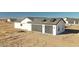 Modern garage with two car spaces, clean lines, and gray doors and trim at 25852 W White Feather Ln, Wittmann, AZ 85361