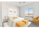 Cozy bedroom features neutral decor, a large window, and modern furnishings for a peaceful retreat at 25876 W White Feather Ln, Wittmann, AZ 85361