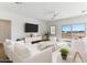 Bright living room with modern furniture and stylish decor, featuring large windows with views of the landscape at 25876 W White Feather Ln, Wittmann, AZ 85361