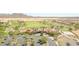 Expansive aerial view of the golf course and community clubhouse with parking at destination property at 25995 W Sierra Pinta Dr, Buckeye, AZ 85396