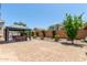 Spacious backyard with a covered patio, brick ground cover, and privacy landscaping at 25995 W Sierra Pinta Dr, Buckeye, AZ 85396