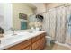Bathroom with sink, framed mirror, and decorative shower curtain at 25995 W Sierra Pinta Dr, Buckeye, AZ 85396