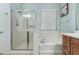 Bathroom featuring a glass-enclosed shower and separate soaking tub near a window at 25995 W Sierra Pinta Dr, Buckeye, AZ 85396