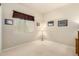 A cozy bedroom with neutral paint, a window, and artwork on the walls at 25995 W Sierra Pinta Dr, Buckeye, AZ 85396