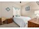 Bright bedroom featuring a cozy bed with white linens and neutral wall color at 25995 W Sierra Pinta Dr, Buckeye, AZ 85396