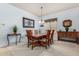 Formal dining room with carpet flooring, chandelier, and seating for six at 25995 W Sierra Pinta Dr, Buckeye, AZ 85396