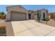 This beautiful home boasts a three-car garage and lovely desert landscaping at 25995 W Sierra Pinta Dr, Buckeye, AZ 85396