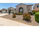 Desert-landscaped home with arched windows and a low-maintenance front yard at 25995 W Sierra Pinta Dr, Buckeye, AZ 85396
