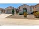 Charming single-story home features desert landscaping, arched windows, and a two-car garage at 25995 W Sierra Pinta Dr, Buckeye, AZ 85396