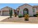 Charming single-story home features desert landscaping, arched windows, and a two-car garage at 25995 W Sierra Pinta Dr, Buckeye, AZ 85396