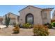 Desert-landscaped home with arched windows and a low-maintenance front yard at 25995 W Sierra Pinta Dr, Buckeye, AZ 85396
