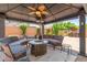 Shaded gazebo with outdoor seating and a fire pit in a backyard setting at 25995 W Sierra Pinta Dr, Buckeye, AZ 85396