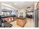 Modern kitchen featuring granite countertops, stainless steel appliances, and ample cabinet space with easy access to dining area at 25995 W Sierra Pinta Dr, Buckeye, AZ 85396
