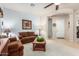 Cozy living room featuring neutral carpet, dual sofas, and a ceiling fan at 25995 W Sierra Pinta Dr, Buckeye, AZ 85396