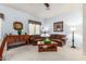 Cozy living room featuring neutral carpet, dual sofas, and a ceiling fan at 25995 W Sierra Pinta Dr, Buckeye, AZ 85396