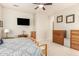 Serene main bedroom featuring warm tones, with a ceiling fan and ample closet space at 25995 W Sierra Pinta Dr, Buckeye, AZ 85396