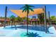 Fun splash pad with palm tree water features and colorful play elements under shade canopies at 25995 W Sierra Pinta Dr, Buckeye, AZ 85396