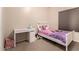 Bedroom featuring a single bed with neutral walls, carpeted floors, and desk at 2922 N 107Th Dr, Avondale, AZ 85392