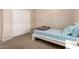 Bedroom featuring a single bed with neutral walls, carpeted floors, and closet at 2922 N 107Th Dr, Avondale, AZ 85392