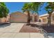 Charming single-story home featuring desert landscaping and a well-manicured lawn with a mature palm tree at 2922 N 107Th Dr, Avondale, AZ 85392