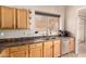 Modern kitchen featuring stainless steel appliances, laminate countertops, and light wooden cabinets at 2922 N 107Th Dr, Avondale, AZ 85392