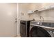 Laundry room featuring new front load washer and dryer with an adjacent exterior door at 2922 N 107Th Dr, Avondale, AZ 85392