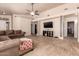 Bright living room with an open layout, complemented by tile flooring, a ceiling fan, and neutral decor at 2922 N 107Th Dr, Avondale, AZ 85392