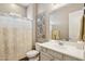 Bright bathroom featuring a single sink, a framed mirror, and a shower with floral print curtain at 3163 E Austin Dr, Gilbert, AZ 85296