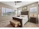 Cozy bedroom featuring a king-sized bed, soft lighting, and a view of the landscaped yard at 3163 E Austin Dr, Gilbert, AZ 85296