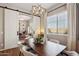 Stylish dining room with modern chandelier, sliding barn door, and comfortable seating for memorable gatherings at 3163 E Austin Dr, Gilbert, AZ 85296