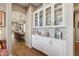 Elegant hallway featuring a glass-door cabinet with fine china leading to a dining area and view to other rooms at 3163 E Austin Dr, Gilbert, AZ 85296
