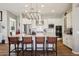 Spacious kitchen boasts a large island with seating, stainless appliances, and modern lighting at 3163 E Austin Dr, Gilbert, AZ 85296