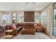 Spacious living room featuring a large leather sectional, stylish decor, and abundant natural light at 3163 E Austin Dr, Gilbert, AZ 85296