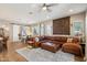 Bright living room features hardwood floors, leather couch, ceiling fan, and decorative wall art at 3163 E Austin Dr, Gilbert, AZ 85296